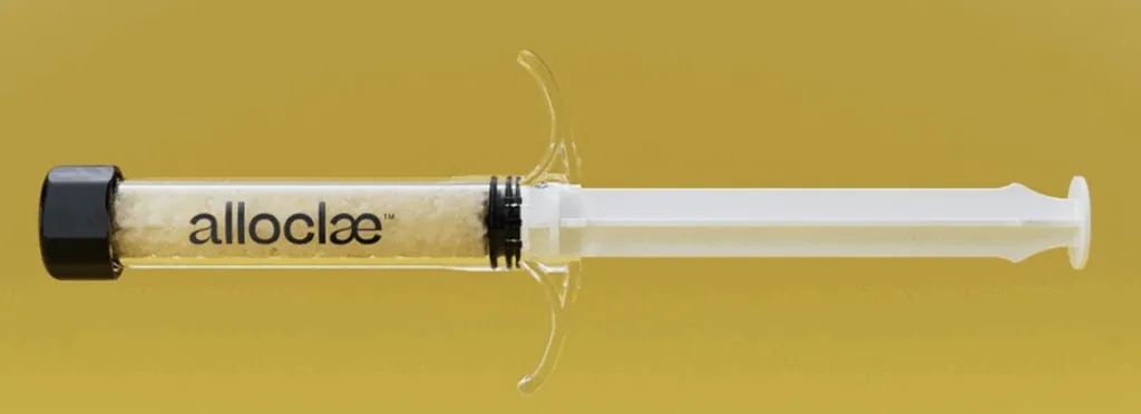 Close-up of AlloClae injectable filler syringe used for non-surgical breast enhancement